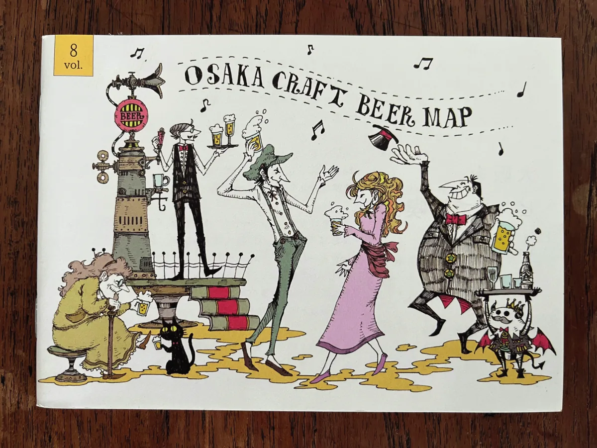 The illustrated cover of the Osaka Craft Beer Map, photographed on a wooden table.