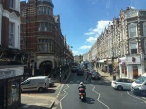 View of Crouch End Clock Tower from the premium seats of a double-decker bus.