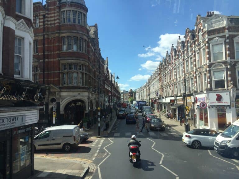 View of Crouch End Clock Tower from the premium seats of a double-decker bus.