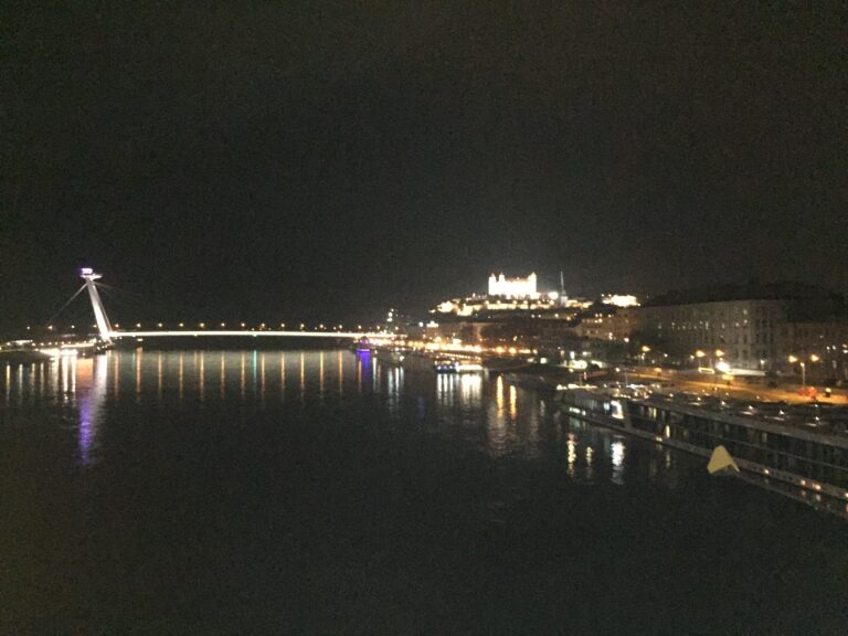 View of Bratislava's hilltop castle by night, taken from a bridge over the Danube.