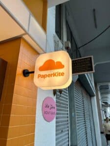 Neon sign displaying PaperKite logo.