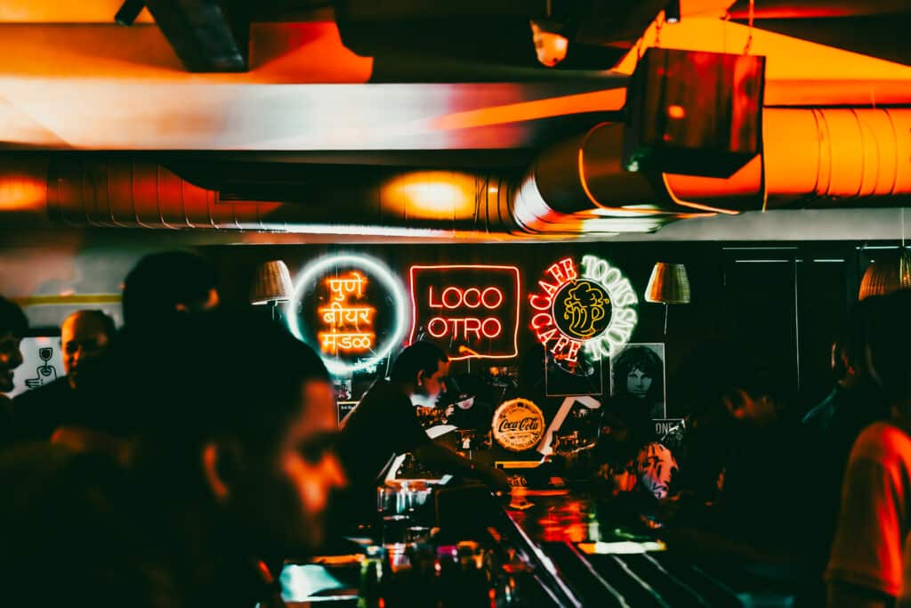 Display of illuminated neon logos of Pune Beer Mandal and Loco Otro, joint organisers of IPA Diwas craft beer festival in Pune, India.