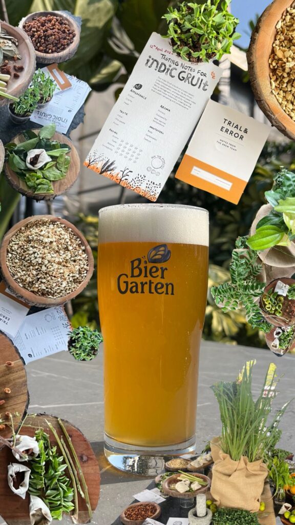 Pint of Biergarten Brewery's Indic Gruit surrounded by bowls filled with some of the botanicals and herbs it contains as well as copies of printed tasting notes.